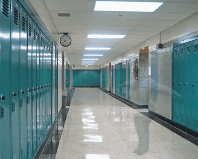 School Hallway With Blue Lockers and Clock at 4:20