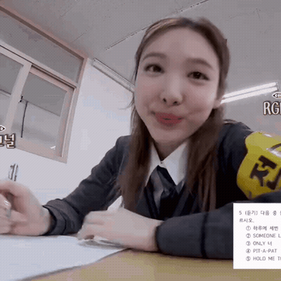 Schoolgirl At Desk With Yellow RJ Armband GIF