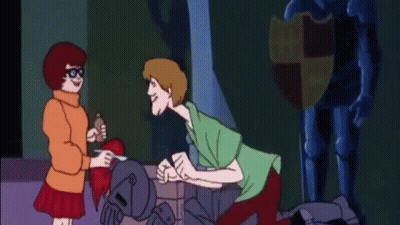 Scooby Doo And Velma Talking In Front Of Statue GIF