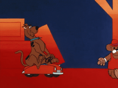 Scooby Doo Is Carrying A Stack Of Boxes In A Red Car GIF