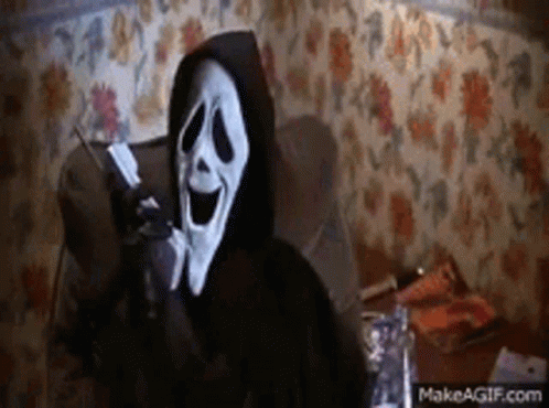 Scream Is Talking On A Cell Phone In A Chair . GIF