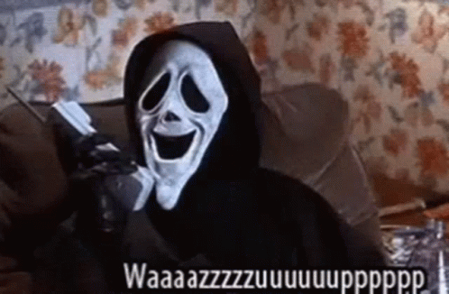 Scream Is Talking On A Cell Phone While Wearing A Hood . GIF