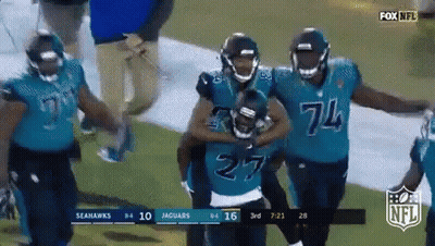 Seahawks And Jaguars Players Walking On Field GIF