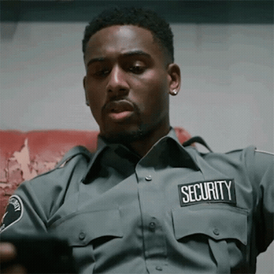 Security Man Looking At Cell Phone GIF