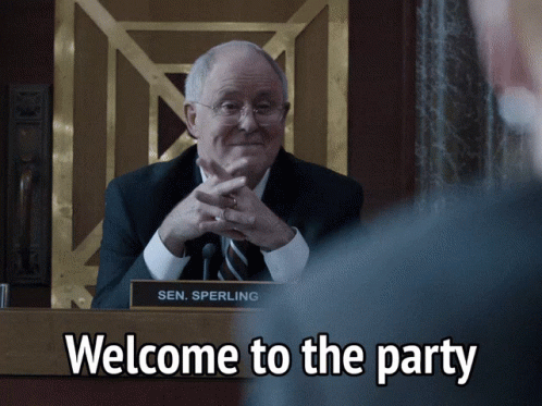 Sen. Sperling Is Sitting At A Podium With The Words Welcome To The Party Below Him GIF