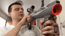 Serious Guy Holding A Toy Bazooka Gun GIF