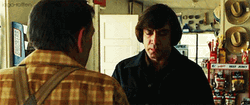 Serious Javier Bardem Coin Flip GIF