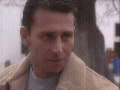 Serious Man In Tan Jacket And Blue Shirt GIF