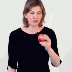 Serious Woman Biting An Apple GIF
