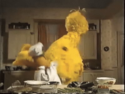 Sesame Street Big Bird Is Dancing In A Kitchen With Plates And Bowls GIF