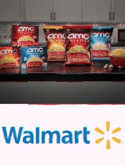 Several Bags Of Amc Popcorn Sit On A Counter GIF