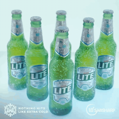 Several Bottles Of Lite Beer Are Lined Up On Ice GIF