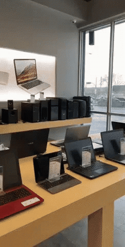 several laptops are on display in a store including one from asus