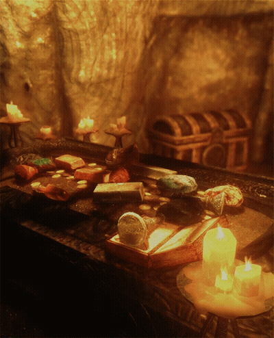 Several Lit Candles On Table With Book GIF