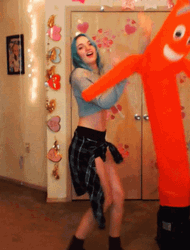 Sexy Lady Dancing With Inflatable Tube Man GIF