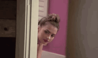 Sexy Lady Peeking Behind The Door GIF