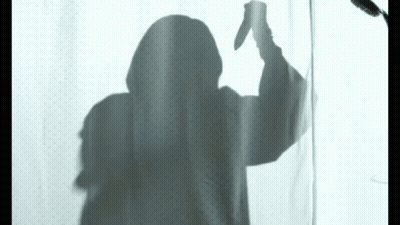 Shadow Of Person Holding Knife Behind Shower Curtain GIF