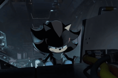 Shadow The Hedgehog Is Sitting In A Dark Room Looking At Something GIF