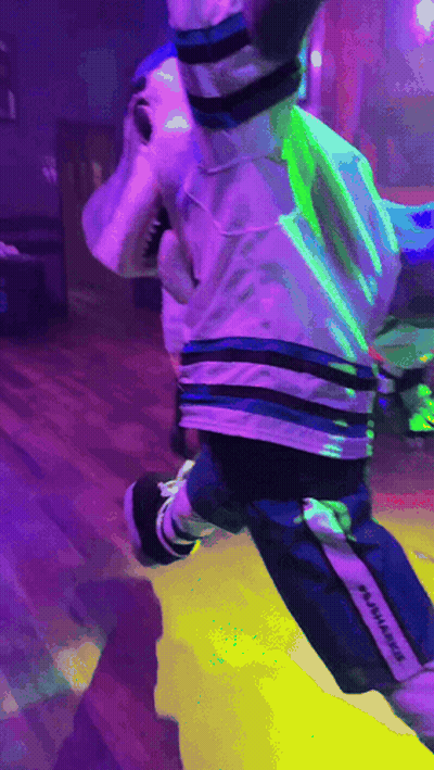 Shark Mascot Jumping With Purple Background GIF
