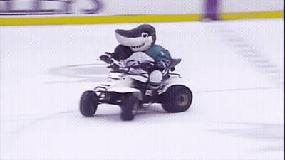 Shark Mascot Riding Four Wheeler On Ice Rink GIF