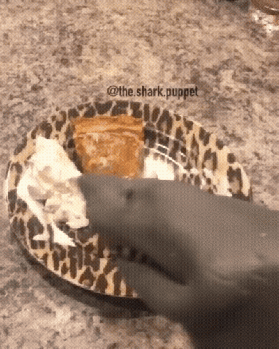 Shark Reaching For Pie On Leopard Print Plate GIF