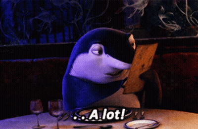 Shark Sitting At Table With A Lot Sign GIF