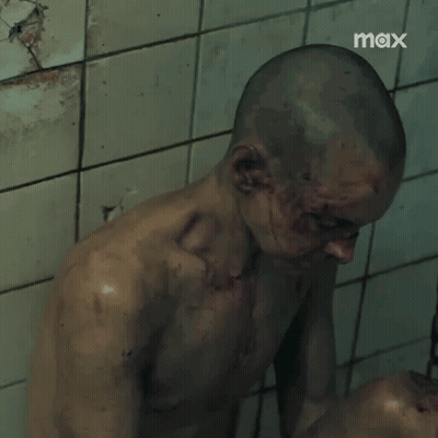 Shaved Head Man Standing Before Tiled Wall Saying Max GIF