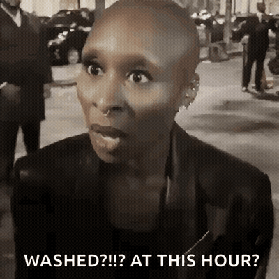 Shaved Head Woman Talking On Street GIF
