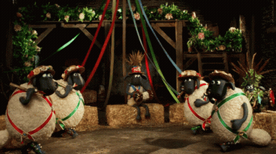 Sheep Wearing Hats And Ribbons In Barn GIF