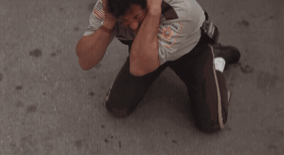 Sheriff Covering Ears In Front Of White Van GIF