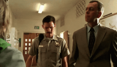Sheriff In Uniform Next To Suit Man GIF