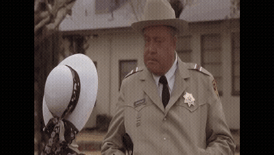 Sheriff Talking To Woman In White Hat GIF