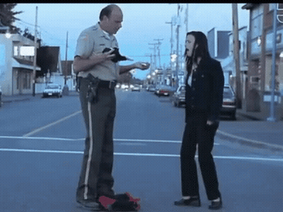 Sheriff Talking To Woman On Street GIF