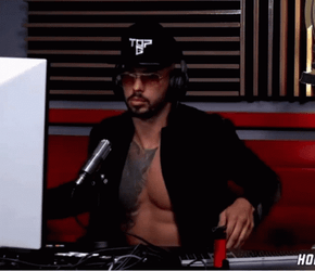 Shirtless Andrew Tate Wearing Cap On Podcast GIF