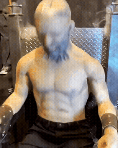 Shirtless Beard Statue Sitting In Chair GIF