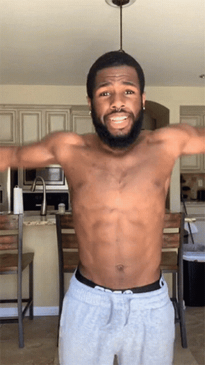 Shirtless Bearded Man Arms Outstretched In Kitchen GIF
