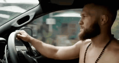 Shirtless Bearded Man Driving Car GIF