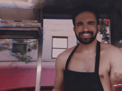 Shirtless Bearded Man In Apron Smiling GIF