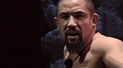 Shirtless Bearded Man Looking At Camera With Microphone GIF