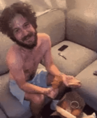 Shirtless Bearded Man Sitting On Couch GIF
