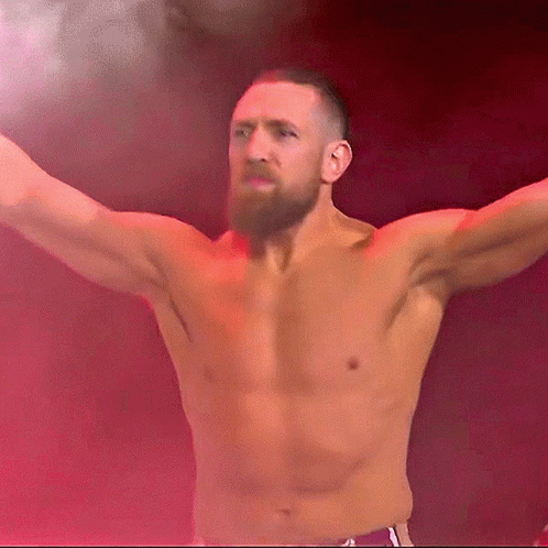 Shirtless Bearded Man Stands In Front Of Red Background GIF