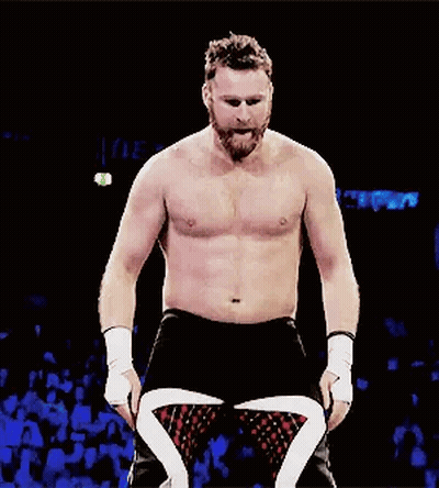 Shirtless Bearded Wrestler In Dark Room Facing Crowd GIF