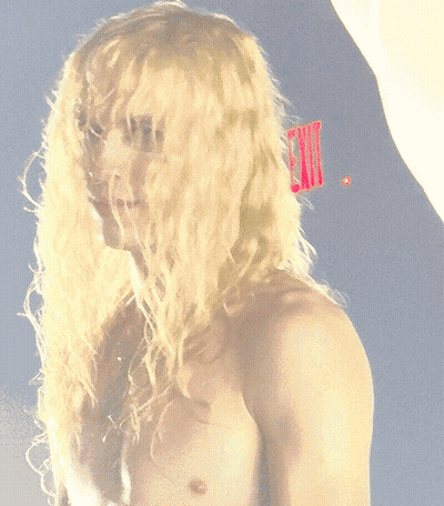 Shirtless Blonde Man With Red Comb In Hair GIF