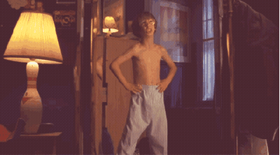 Shirtless Boy Dancing In Dark Room With Lamp GIF