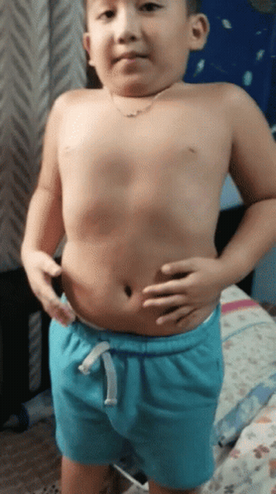 Shirtless Boy In Blue Shorts Holding Belly GIF