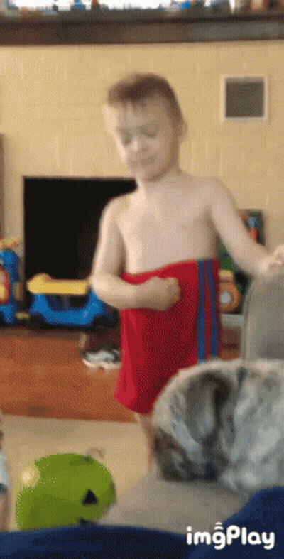 Shirtless Boy In Red Shorts Standing With Cat GIF