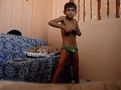 Shirtless Boy Playing Video Game With Controller GIF