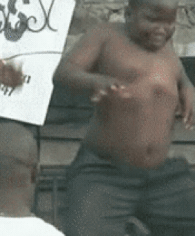 Shirtless Child Sitting Next To Man Holding Sign GIF