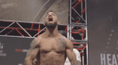 Shirtless Fighter In Front Of Hea Sign GIF