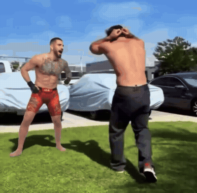 Shirtless Fighter In Red Shorts Next To Shirtless Fighter In Black Jeans GIF